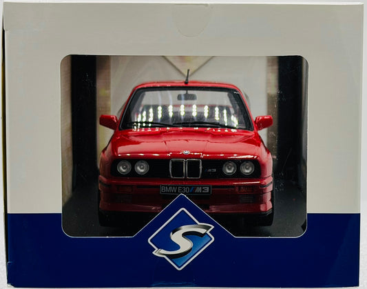 Red model car in a display box with a visible brand logo.