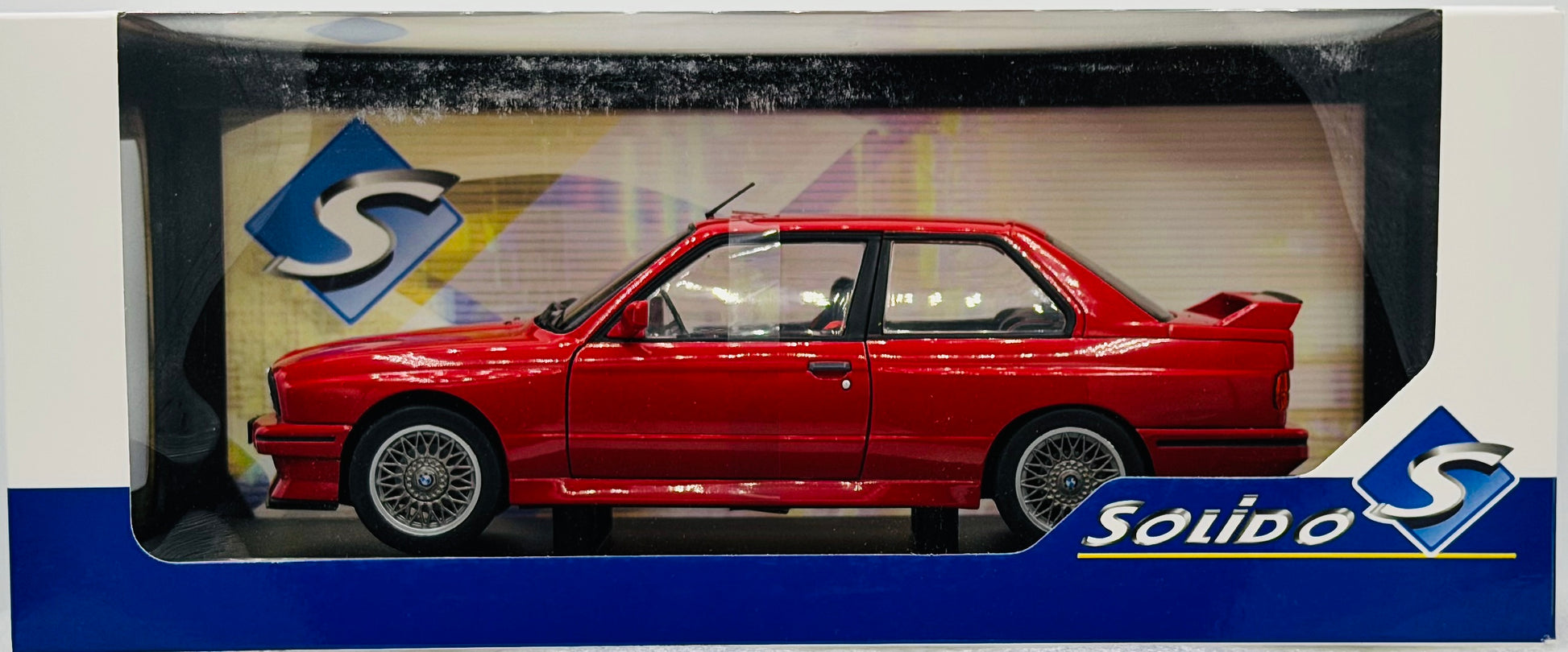 Red car model in a Solido box with branding