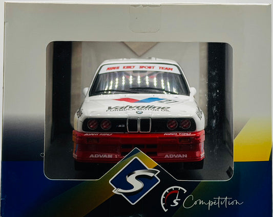 Model car in a display case with visible branding and logos.