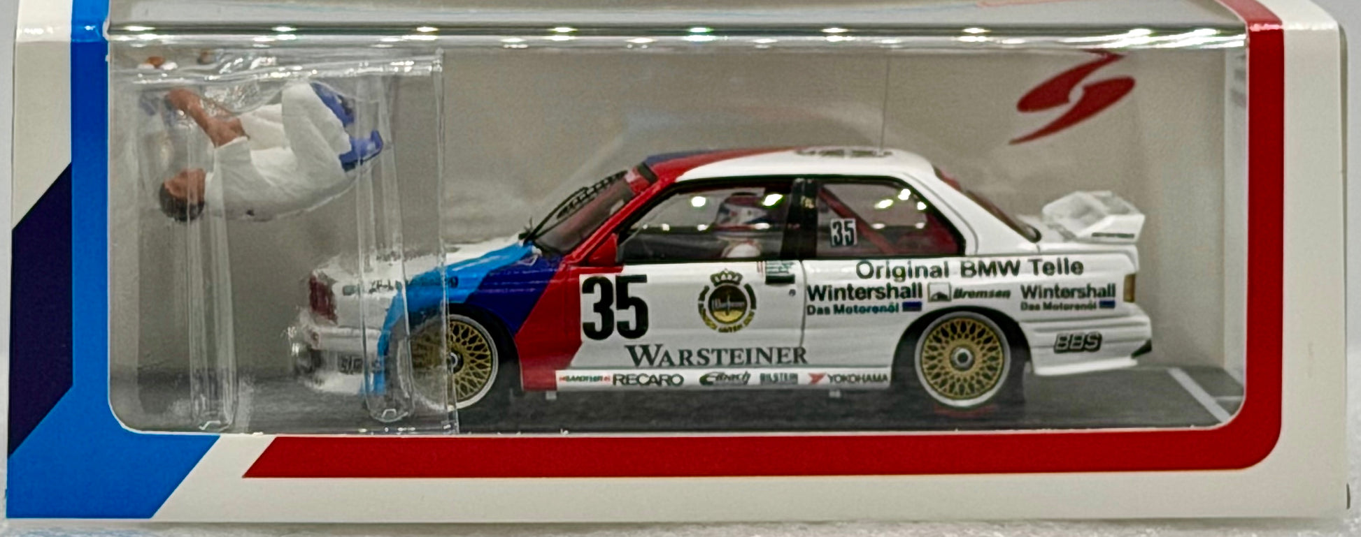 Model car in a display case with branding and details.