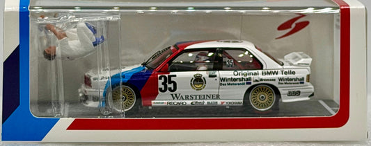 Model car in a display case with branding and details.